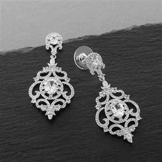 Silver Victorian Scrolls Earrings These fabulous silver plated bridal earrings glisten with AAAAA quality CZ crystals in a beautiful vintage inspired chandelier design. This romantic Victorian inspired accessory will add a glamorous touch to any wedding gown, bridesmaid gown or evening dress. These jewel-encrusted CZ earrings with glistening oval-cut crystals have platinum silver rhodium plating. Available in pierced or clip on styles. Size: 2 1/16" long and 7/8" wide. Color: Silver. Style: 4553 Dangle Gauges, Gold Bar Earrings Studs, Pageant Earrings, Silver Bridal Earrings, Crystal Statement Earrings, Jewel Encrusted, Silver Crystal Earrings, Bridal Earrings Chandelier, Earrings Sparkle