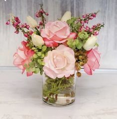 a vase filled with pink and white flowers