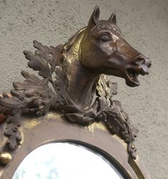 a horse head is on top of a mirror