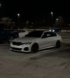 two cars parked in a parking lot at night