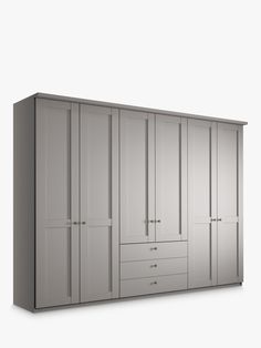 a large white closet with drawers and doors