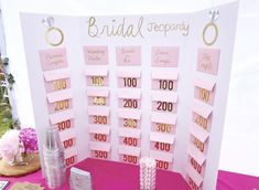 a table topped with lots of pink and gold cards on top of a purple table cloth