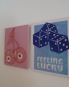 two greeting cards with dice and cherries on them, one is pink and the other is blue