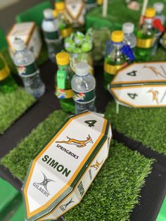 the table is set up with sports drinks and water bottles for an ultimate rugby party