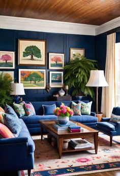 a living room with blue couches and pictures on the wall above them, along with two lamps