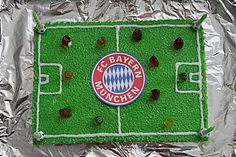 a cake that looks like a soccer field with the logo of bavarian football team on it