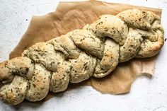 a piece of bread that has been braided into it on top of wax paper