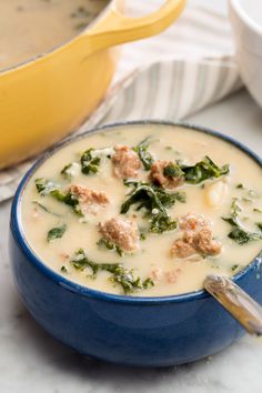 a bowl of soup with meat and spinach