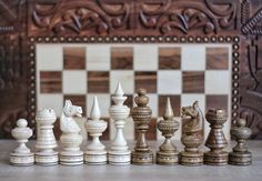 the chess board is made out of wood and has several pieces on it, including one king