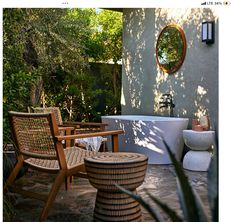 an outdoor bathtub surrounded by wooden chairs