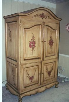 an old wooden armoire in the corner of a room