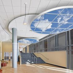 an empty building with stairs and sky in the background