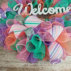 a colorful mesh wreath with the word welcome on it