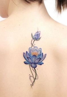 the back of a woman's shoulder with blue flowers on it