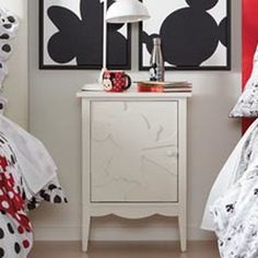 two beds with mickey and minnie mouse bedding in a bedroom next to each other