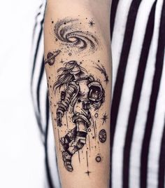 an astronaut tattoo on the right arm and left arm, with stars in the background