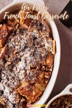 french toast casserole with powdered sugar on top and spoons next to it