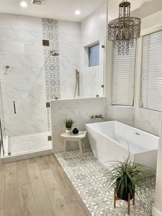 a bathroom with a tub, sink and shower