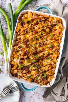 a casserole dish with green onions and cheese