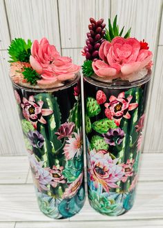 two vases with flowers painted on them