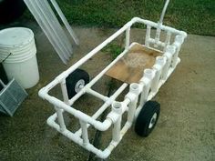 a white cart with wheels is sitting on the ground