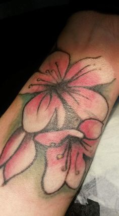 a close up of a person's arm with flowers on it