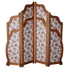 a room divider with floral fabric and wood trimmings on the sides,