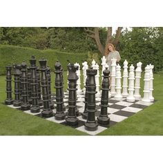 the giant chess set is ready to be played in the park or on the lawn