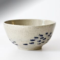 a white bowl with blue speckles on it