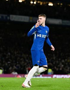 soccer player in blue uniform on field during game