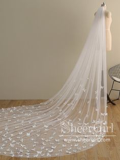 a wedding veil with white flowers on it