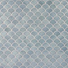 an abstract blue and white tile pattern with wavy lines in the shape of fish scales