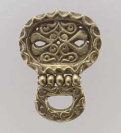 an antique brass door handle with ornate designs