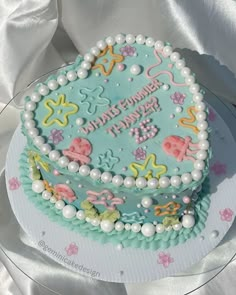 a birthday cake decorated with sea creatures and pearls