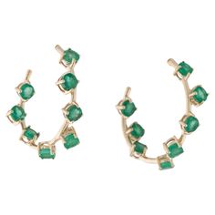 These stunning 14K Yellow Gold inside-out hoop earrings feature 2.16 carats of round modified brilliant emeralds. Each of the 16 emeralds displays a captivating green hue with slight inclusions, enhancing their natural beauty. Measuring 0.75 inches in length and 0.25 inches in width, these earrings offer a versatile 3/4 hoop design that is both elegant and bold. Perfect for women seeking a balance of timeless style and vibrant gemstones, these hoops are sure to elevate any look, whether for ever Bracelet Love, Cartier Love, Green Gemstones, Fine Jewelry Collection, Modern Earrings, Love Ring, Jewelry Earrings Hoops, Gold Jewelry Fashion, Round Earrings