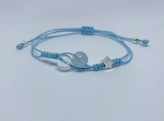 a blue string bracelet with two silver stars on it