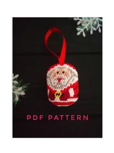 a christmas ornament with a santa clause on it and snowflakes in the background