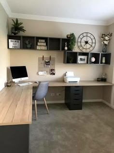 a home office with two desks and a clock on the wall above it's shelves