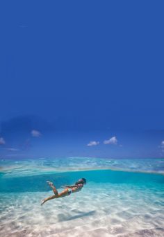 a woman swimming in the ocean with her feet above water and words below it that read health benefits of swimming