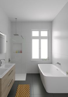 a bathroom with a large white bathtub next to a sink