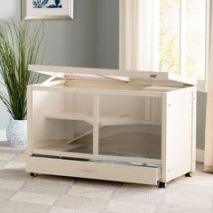 a white cabinet with glass doors in a living room