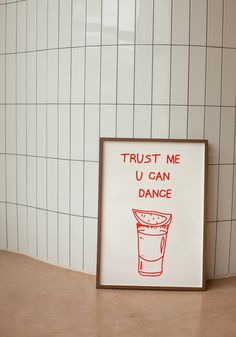 a sign that says trust me u can dance in front of a wall with white tiles