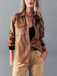 "Faux Leather Button Down Shirt. This edgy and stylish shirt is crafted from high-quality faux leather, adding a touch of sophistication and trendiness to your fall and winter outfits. NO REFUNDS-please check sizing Small (2/4), Medium (6/8), Large (10) Small  Bust (8\" below Shoulder Point): 35\"  Sleeve\" 21\"  Length (Should point to Longest Bottom Hem/ Sides are shorter): 26.5\" Medium  Bust (8\" below Shoulder Point): 36\"  Sleeve\" 21.5\"  Length (Should point to Longest Bottom Hem/ Sides are shorter): 27\" Large  Bust (8\" below Shoulder Point): 37.5\"  Sleeve\" 22\"  Length (Should point to Longest Bottom Hem/ Sides are shorter): 27\" Featuring a classic button-down design with snap buttons, this shirt offers both style and ease of wear. The chest pocket adds a functional and fashi Leather Button-up Tops With Button Closure, Casual Brown Leather Tops, Brown Leather Casual Tops, Casual Brown Leather Top, Trendy Long Sleeve Faux Leather Top, Trendy Faux Leather Long Sleeve Top, Leather Button-up Top With Pockets, Trendy Faux Leather Tops For Fall, Trendy Long Sleeve Leather Top