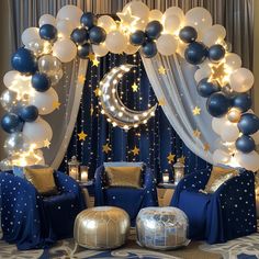 a room decorated with balloons, stars and moon decorations