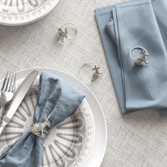 the table is set with napkins, silverware and other items to be used as place settings