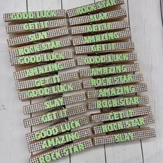 green and white glittered name tags on wooden boards with words that spell out good luck