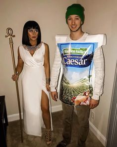 a man and woman in costume standing next to each other with an odd shirt on