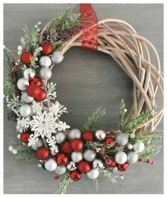 a christmas wreath with red, white and silver ornaments