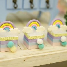 three small toy rainbows sitting on top of a table