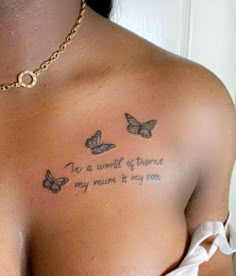 a woman's chest with three butterflies on it and the words to be written in cursive writing